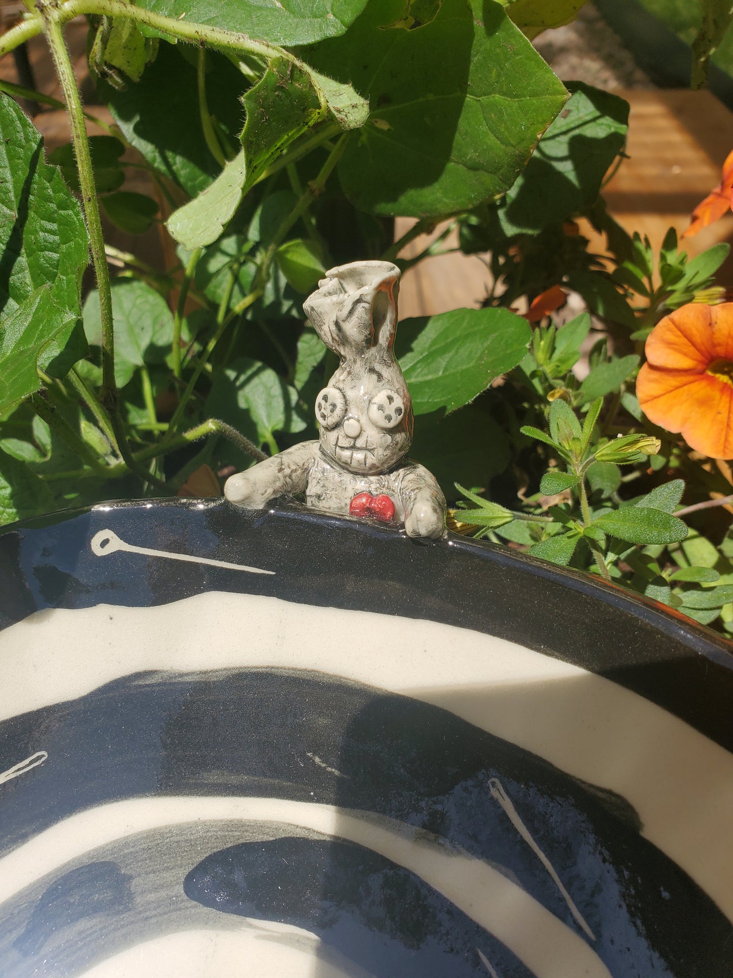 Black and white bowl with Voodoo Doll