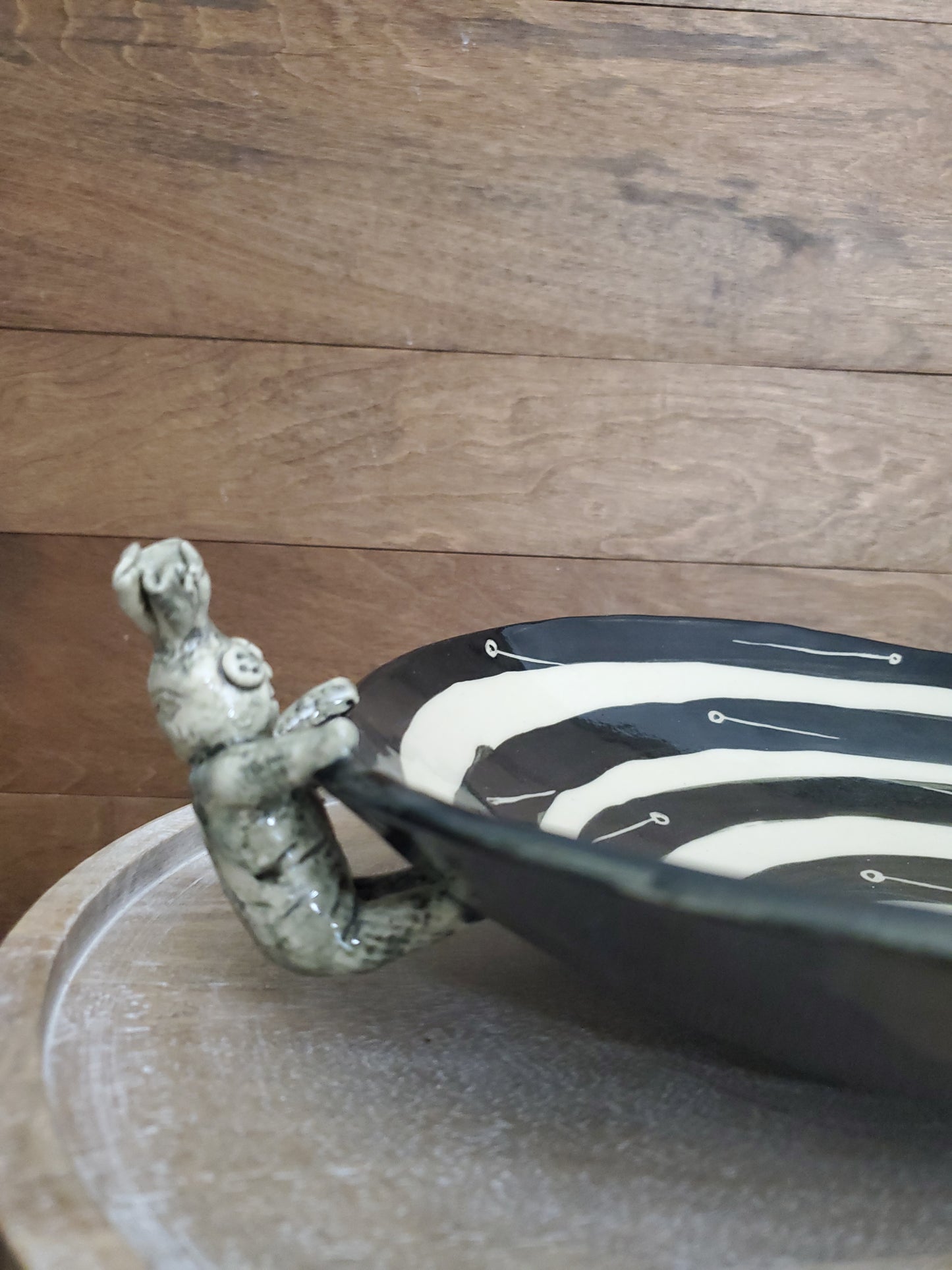 Black and white bowl with Voodoo Doll